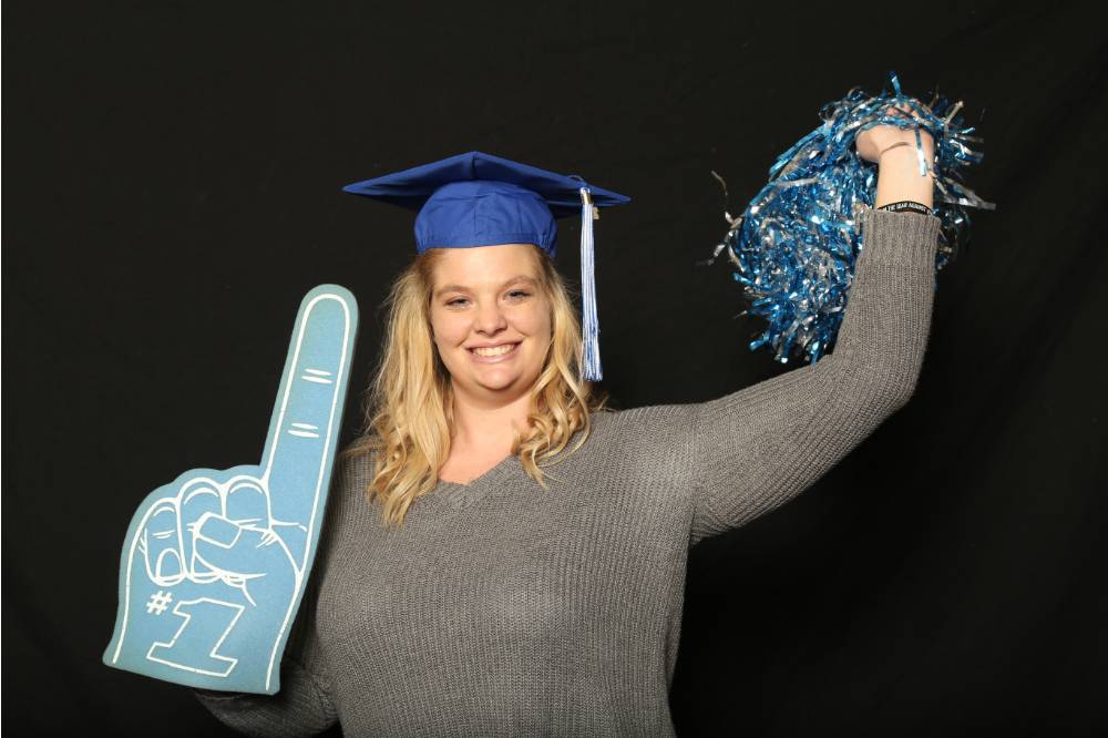 soon to be graduate with pom pom and foam finger